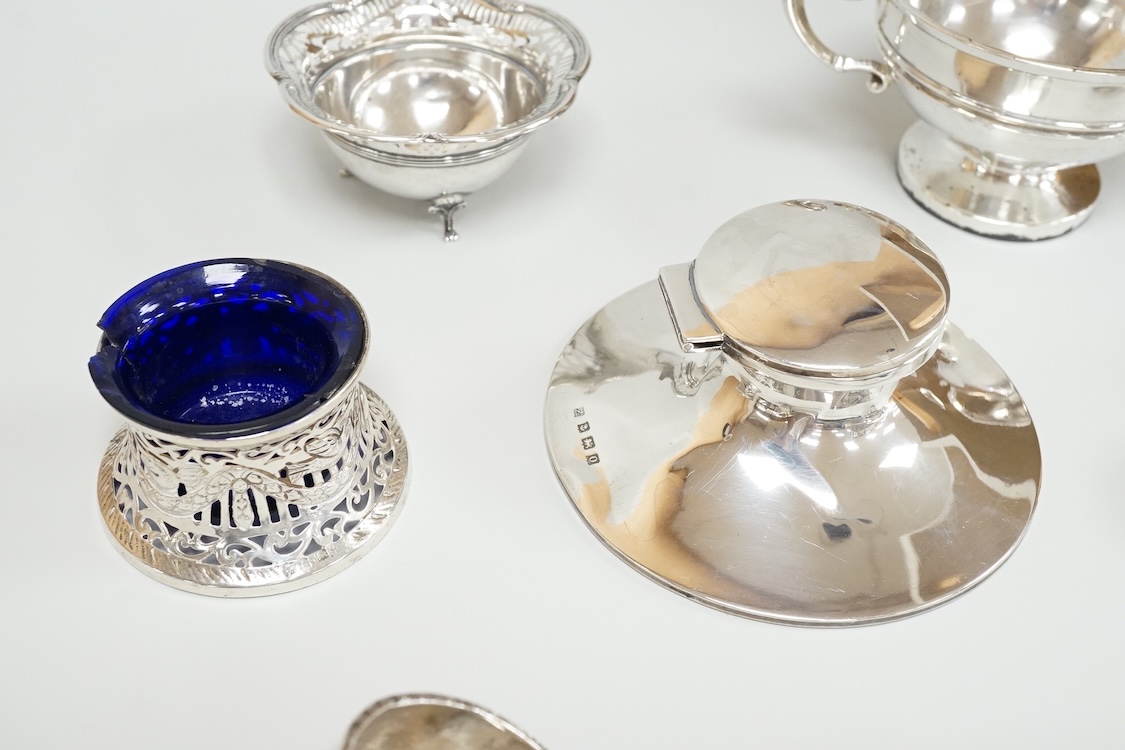 A George V silver mounted capstan inkwell, A & J Zimmerman Ltd, Birmingham, 1913, diameter 11.4cm, together with a small silver bowl, a small silver 'dish ring' salt(a.f.), a silver two handled bowl, a silver pill box an